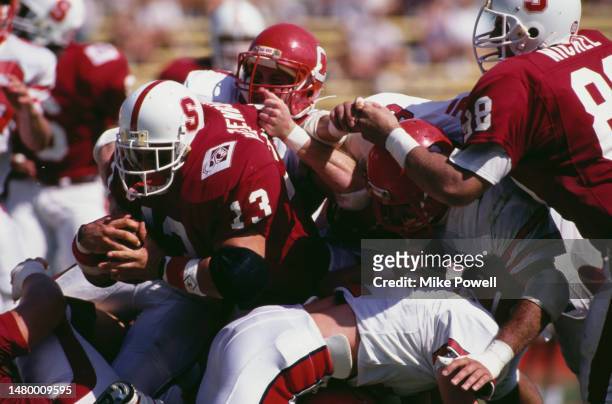 Mark Hatzenbuhler, Running Back for the University of Stanford Cardinal in motion running the football is tackled to the ground during the NCAA...