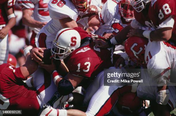 Mark Hatzenbuhler, Running Back for the University of Stanford Cardinal in motion running the football is tackled to the ground during the NCAA...