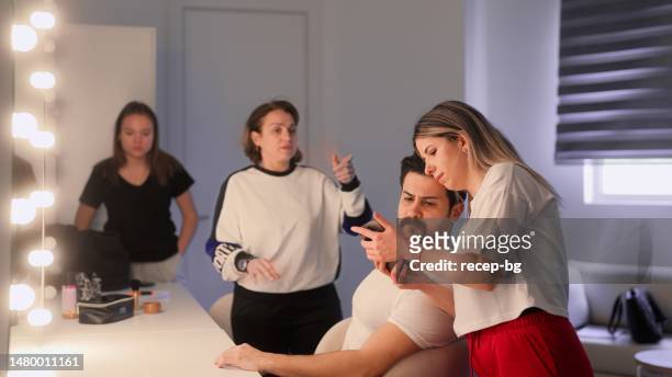 group of performers getting ready in dressing room in backstage - actress backstage stock pictures, royalty-free photos & images