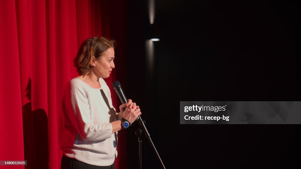 Female director talking to audiences and introducing performance and play on stage