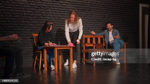 group of theater stage performers performing on stage - improvisatie stockfoto's en -beelden