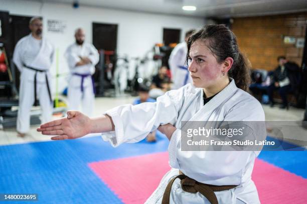 teenage girl training during a karate class - taekwondo stock pictures, royalty-free photos & images