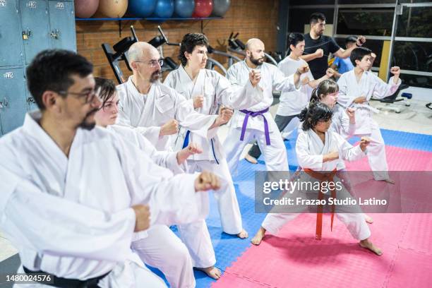 karate students practicing during a karate class - dojo stock pictures, royalty-free photos & images