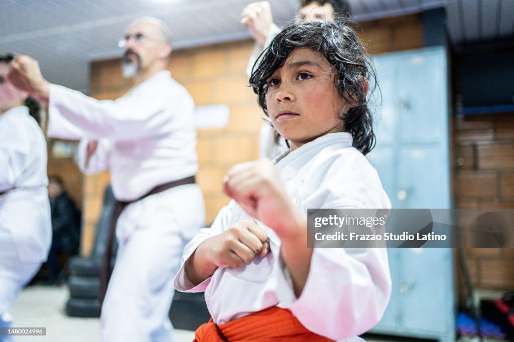 Child boy practicing during a karate class