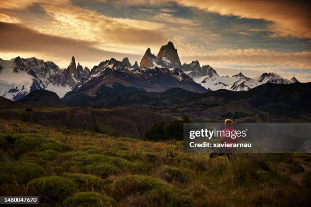 active senior female photographer hiking near mount fitz roy - santa cruz province argentina stock pictures, royalty-free photos & images