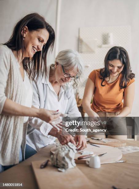 female siblings modeling clay together - ceramics stock pictures, royalty-free photos & images