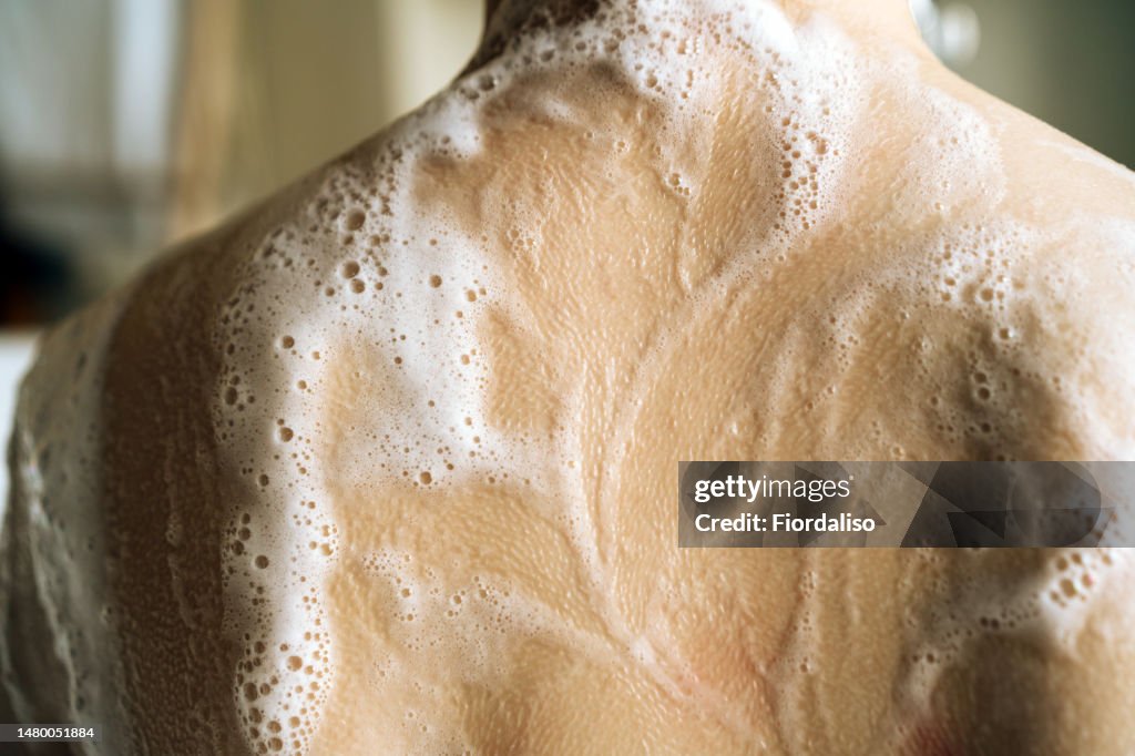 Woman taking a bubble bath. Relaxation and beauty treatments. Natural beauty, daily skincare routine. Moisturizing, cleansing