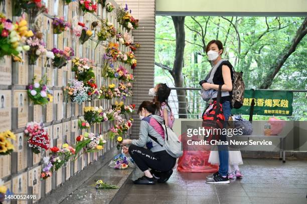 Woman prepares flowers at the Diamond Hill Cemetery during Qingming Festival, or Tomb-Sweeping Day on April 5, 2023 in Hong Kong, China.