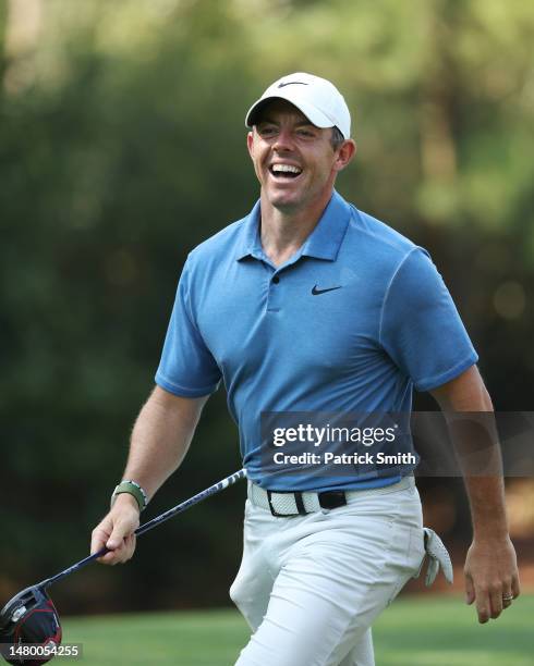 Rory McIlroy of Northern Ireland laughs as he walks to the 11th tee during a practice round prior to the 2023 Masters Tournament at Augusta National...