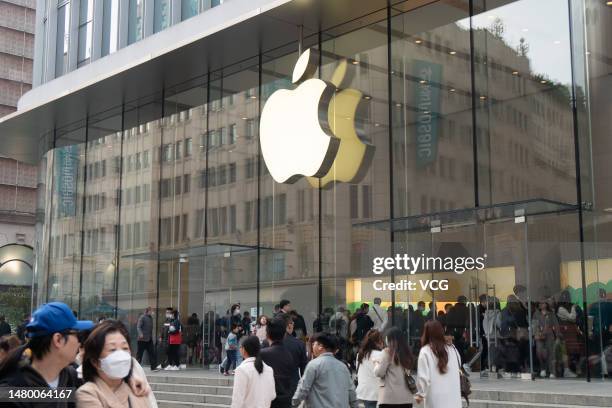People walk by an Apple Store at Nanjing Road pedestrian street on April 5, 2023 in Shanghai, China.