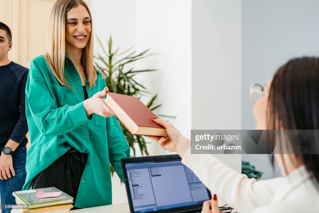 Female Student Renting A Book In A School Library High-Res Stock Photo ...