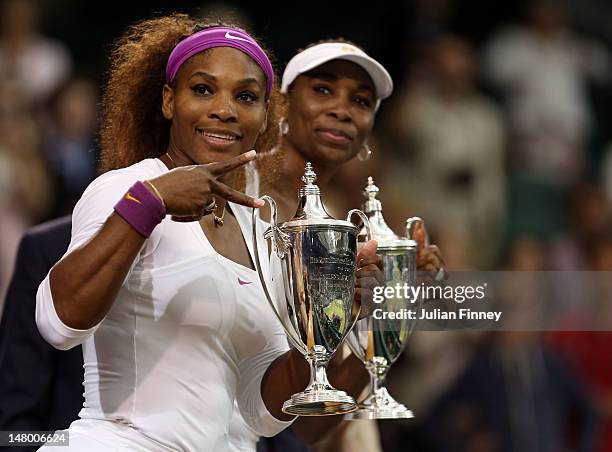 Serena Williams and Venus Williams of the USA celebrate with their winners trophies after their Ladies’ Doubles final match against Andrea Hlavackova...