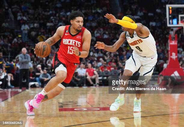 Daishen Nix of the Houston Rockets dribbles the ball against Peyton Watson of the Denver Nuggets during the game at Toyota Center on April 04, 2023...