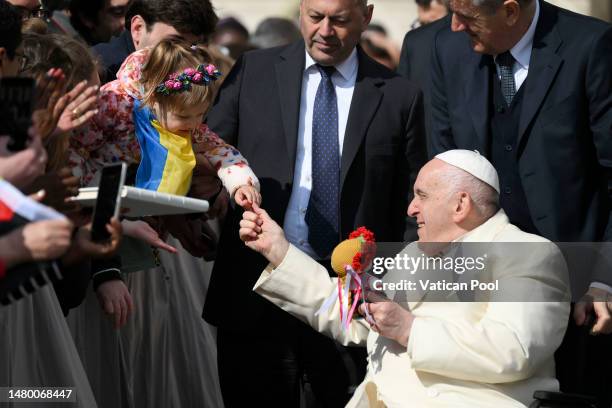 Pope Francis greets a girl from Ukraine at St. Peter's Square during his general audience on April 05, 2023 in Vatican City, Vatican. Addressing the...