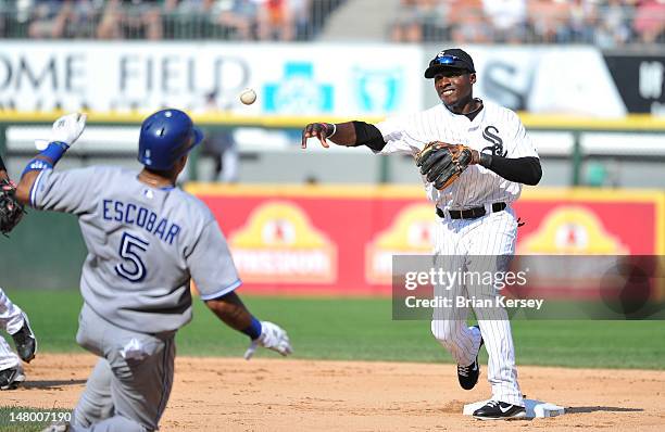 Second baseman Orlando Hudson of the Chicago White Sox turns a double play as Yunel Escobar of the Toronto Blue Jays slides into second base on a...