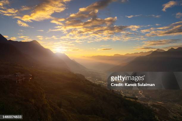 sunrise over mountain range in sapa, lao cai, vietnam with dramatic sky - dark forest stock pictures, royalty-free photos & images