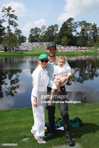 Thomas Pieters of Belgium poses with Stefanie van Steen and their child during the Par 3 contest prior to the 2023 Masters Tournament at Augusta...