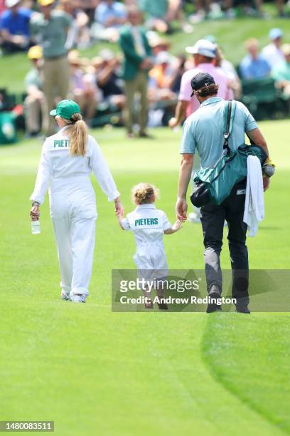 Thomas Pieters of Belgium poses with Stefanie van Steen and their child walk down the fairwayduring the Par 3 contest prior to the 2023 Masters...