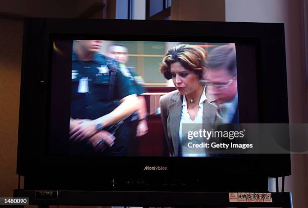In an image taken from television, Noelle Bush leaves an Orange County courtroom in handcuffs October 17, 2002 in Orlando, Florida. Bush, the...
