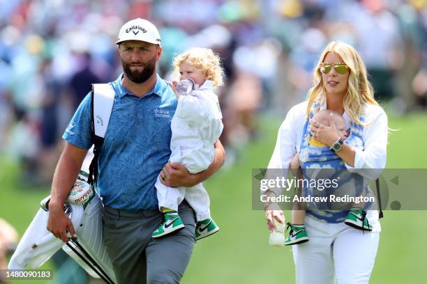 Jon Rahm of Spain and his wife, Kelley, and his children Eneko and Kepa, look on during the Par 3 contest prior to the 2023 Masters Tournament at...