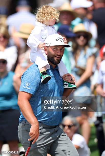 Jon Rahm of Spain walks with his son, Kepa, during the Par 3 contest prior to the 2023 Masters Tournament at Augusta National Golf Club on April 05,...