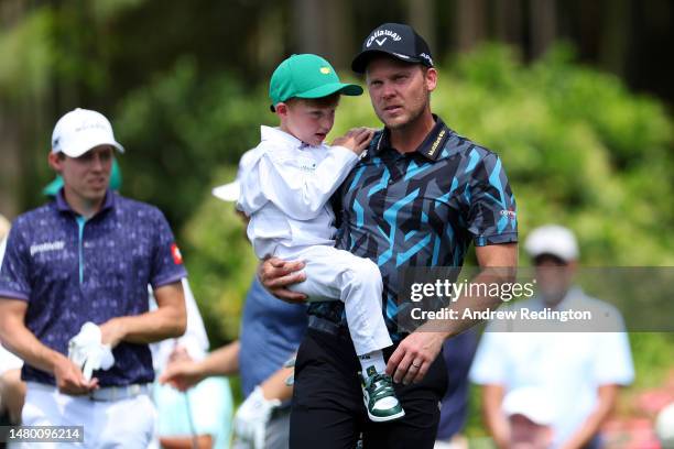 Danny Willett of England looks on with his son during the Par 3 contest prior to the 2023 Masters Tournament at Augusta National Golf Club on April...