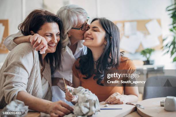 women molding clay - mother and daughter kissing stock pictures, royalty-free photos & images