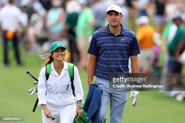 Scottie Scheffler of the United States walks up the fairway with his wife, Meredith Scheffler, during the Par 3 contest prior to the 2023 Masters...