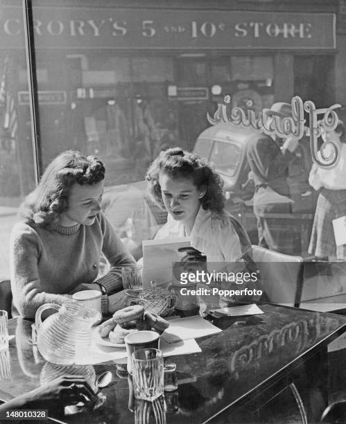 Martha Jean Kuhn shows a friend a letter from her boyfriend, an American airman stationed in Britain during World War II, Grafton, West Virginia,...