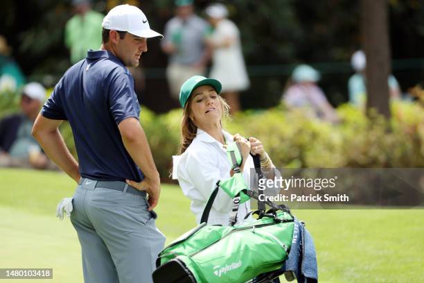 Scottie Scheffler of the United States walks with his wife, Meredith Scheffler, during the Par 3 contest prior to the 2023 Masters Tournament at...