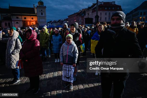 Child holds an image with Vladimir Putin behind bars as Ukrainians and Poles hold flags during a speech by Ukraine’s President, Volodymyr Zelenskyy...