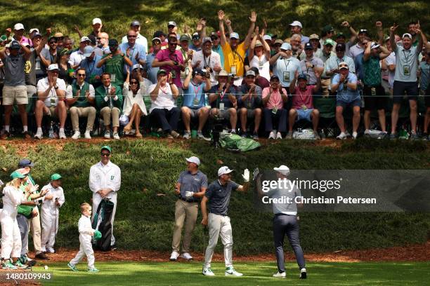 Seamus Power of Ireland high fives Keegan Bradley of the United States on the ninth hole during the Par 3 contest prior to the 2023 Masters...