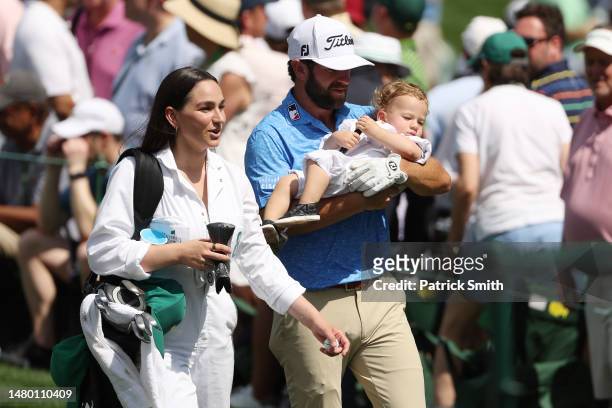 Cameron Young of the United States looks on with his wife Kelsey, and son Henry during the Par 3 contest prior to the 2023 Masters Tournament at...