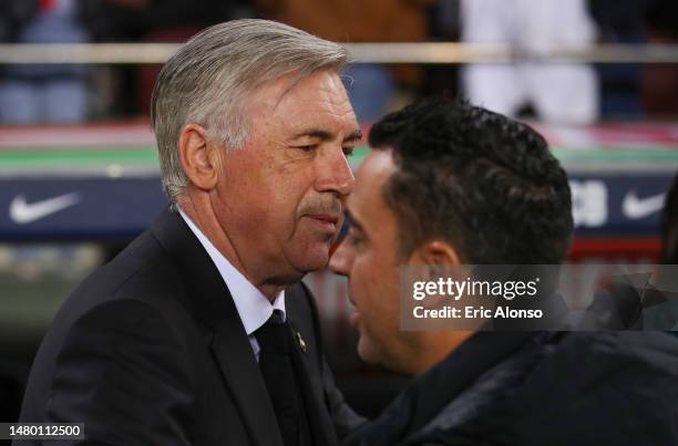 Carlo Ancelotti, Manager of Real Madrid, interacts with Xavi, Head Coach of FC Barcelona, prior to the Copa Del Rey Semi Final Second Leg match...