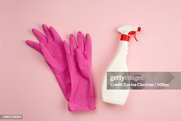 latex gloves,spray lying on a pink background,copy space,romania - rubber gloves stockfoto's en -beelden