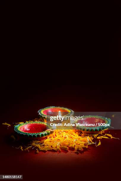 happy diwali - clay diya lamps lit during diwali celebration greetings card design of indian hindu,romania - hinduism fotografías e imágenes de stock