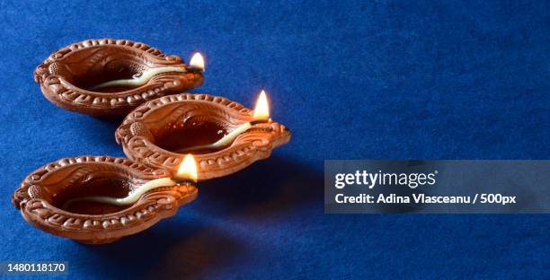 clay diya lamps lit during diwali celebration greetings card design indian hindu light festival cal,romania - diya oil lamp stock-fotos und bilder