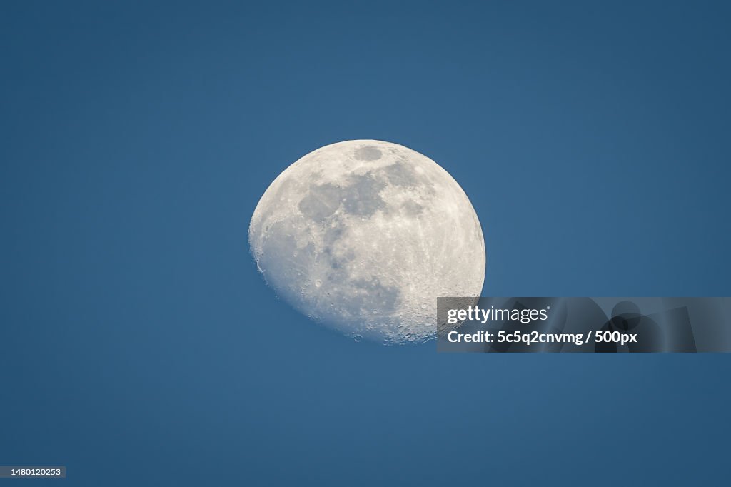 Low angle view of moon against clear blue sky,Switzerland