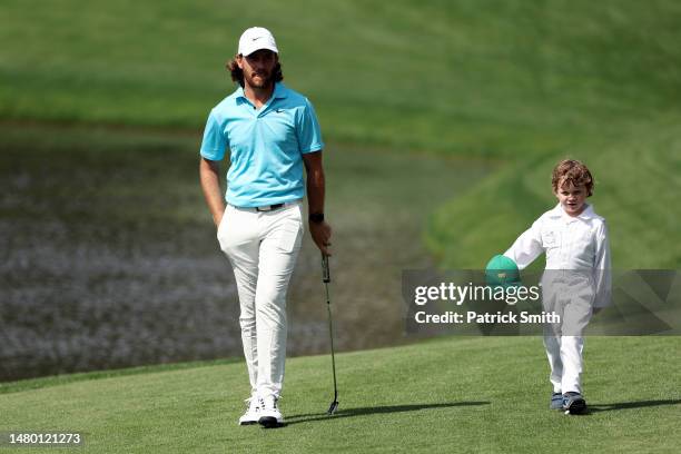 Tommy Fleetwood of England walks with his son, Franklin, during the Par 3 contest prior to the 2023 Masters Tournament at Augusta National Golf Club...