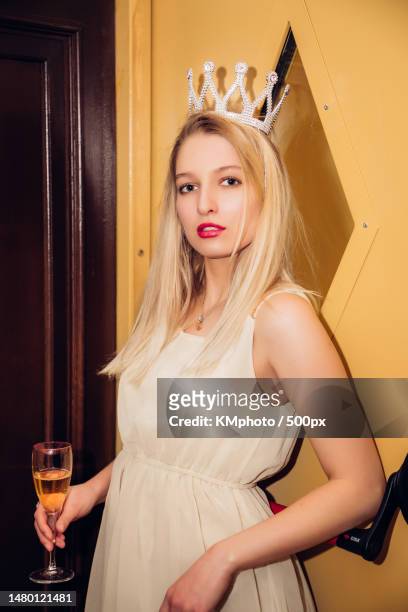 pretty blonde female in short dress wearing a crown,holding glass of wine,champagne,juice kmphoto,russia - kmphoto stock pictures, royalty-free photos & images
