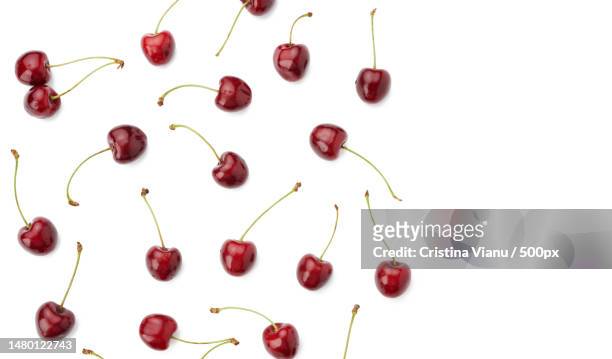 whole ripe red juicy sweet cherries isolated on a white background,top view,flat lay,romania - cherry on top stock-fotos und bilder