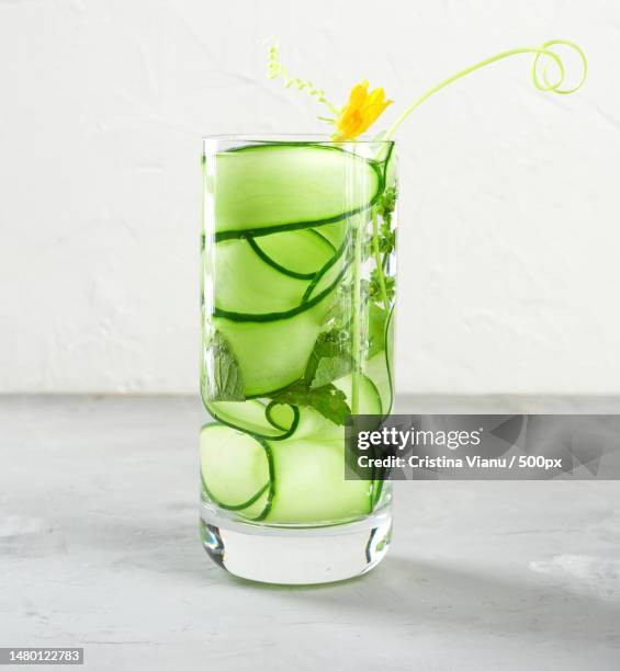 transparent glass with cucumber pieces,mint leaves and mineral water,romania - cucumber leaves stock pictures, royalty-free photos & images