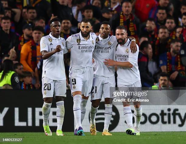 Vinicius Junior of Real Madrid celebrates with teammates Karim Benzema, Rodrygo and Daniel Carvajal after scoring the team's first goal during the...