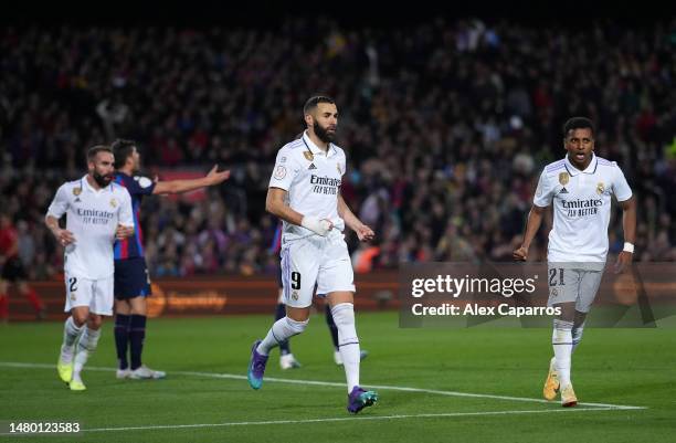 Karim Benzema and Rodrygo of Real Madrid run towards teammate Vinicius Junior as he celebrates after scoring the team's first goal during the Copa...