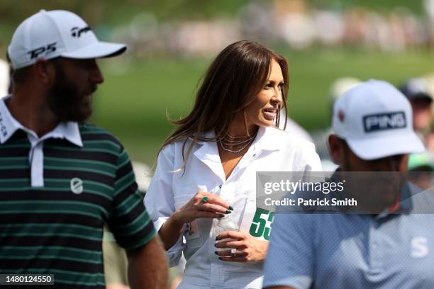 Dustin Johnson of the United States wife, Paulina Gretzky, looks on during the Par 3 contest prior to the 2023 Masters Tournament at Augusta National...