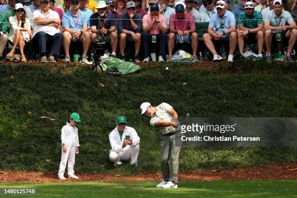 Si Woo Kim of South Korea plays his shot from the ninth tee during the Par 3 contest prior to the 2023 Masters Tournament at Augusta National Golf...