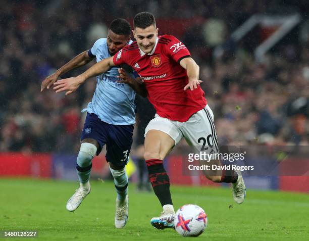 Diogo Dalot of Manchester United battles for possession with Rico Henry of Brentford during the Premier League match between Manchester United and...