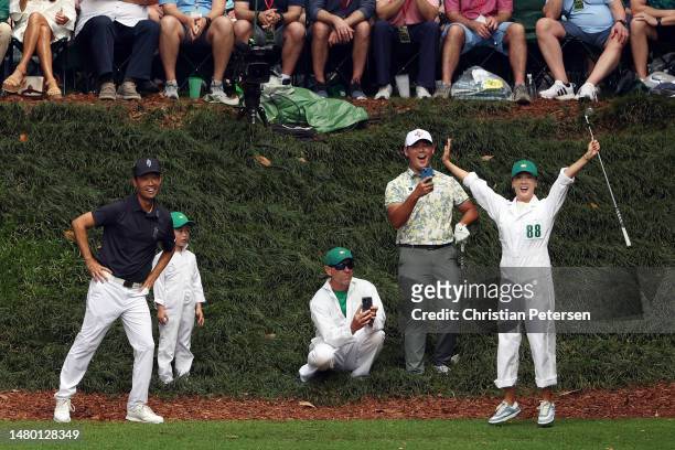 Si Woo Kim of South Korea and his wife, Ji Hyun Oh, reacts on the ninth tee during the Par 3 contest prior to the 2023 Masters Tournament at Augusta...