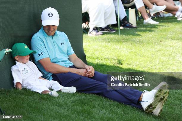 Jordan Spieth of the United States talks with his son, Sammy Spieth, during the Par 3 contest prior to the 2023 Masters Tournament at Augusta...