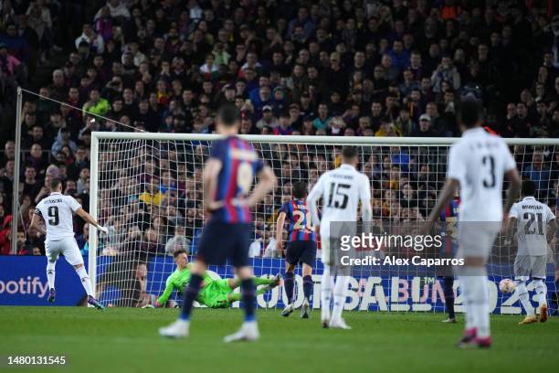 Karim Benzema of Real Madrid scores the team's third goal past Marc-Andre ter Stegen of FC Barcelona from a penalty kick during the Copa Del Rey Semi...
